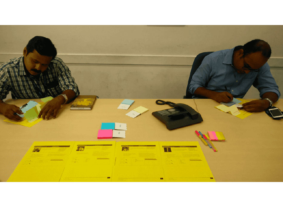 Co-creation workshop — participants sketching deal flows on paper at a table